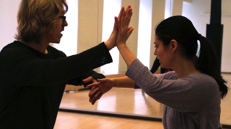 Brian Strimpel Demonstrates with a dancer how to distribute weight in a partnering class